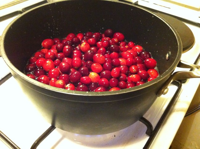 Fresh cranberries swimming in boiling sugar water